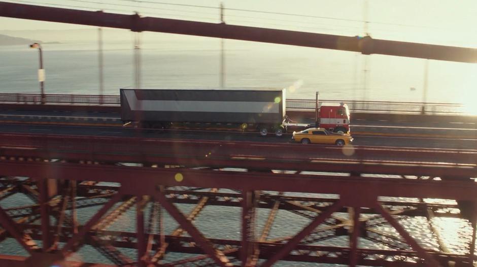 Bumblebee drives away past a familier-looking semi in his new Camaro form.