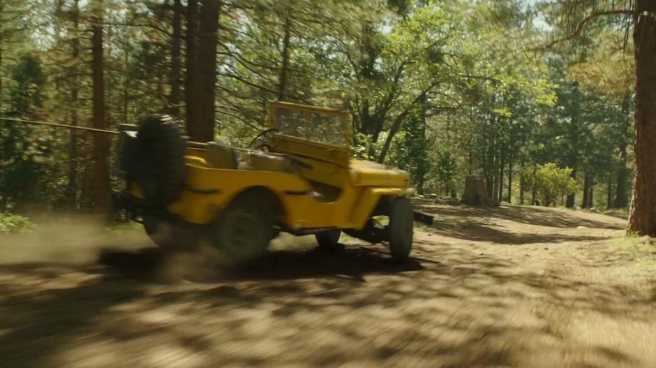 Bumblebee turns into a Jeep and drives down the dirt road.