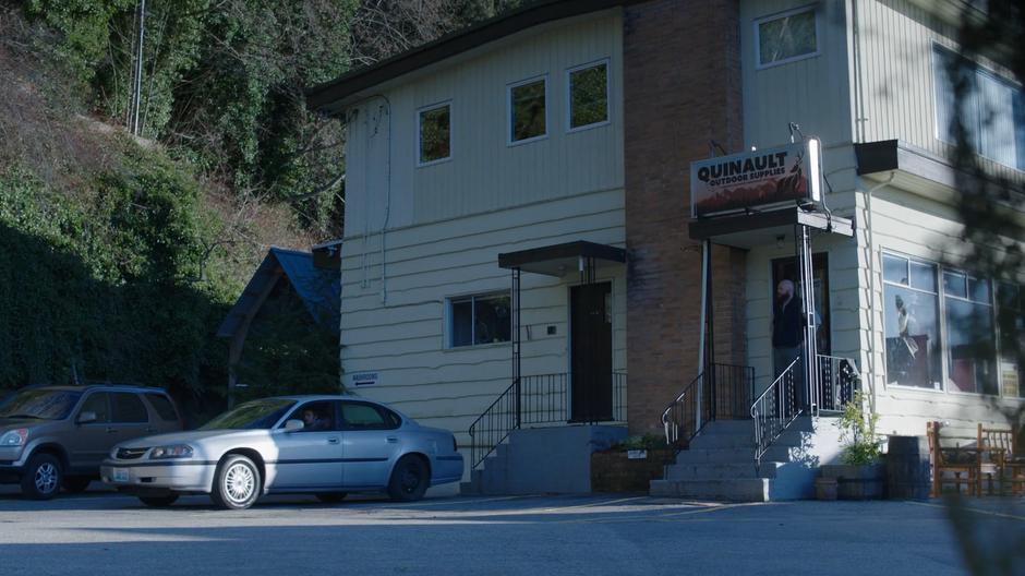 The trio drives away while the clerk steps out of the door and watches them leave.