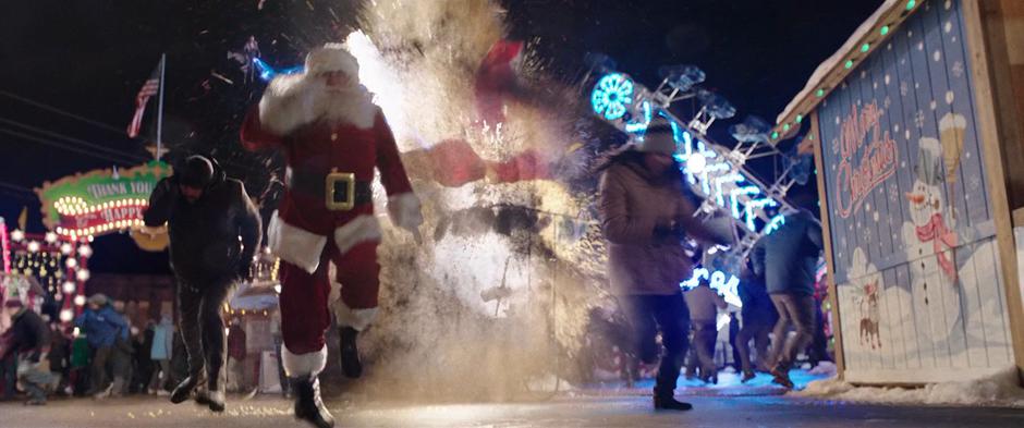 Santa and others run away from an explosion caused by Sivana who is flying in the air behind them.