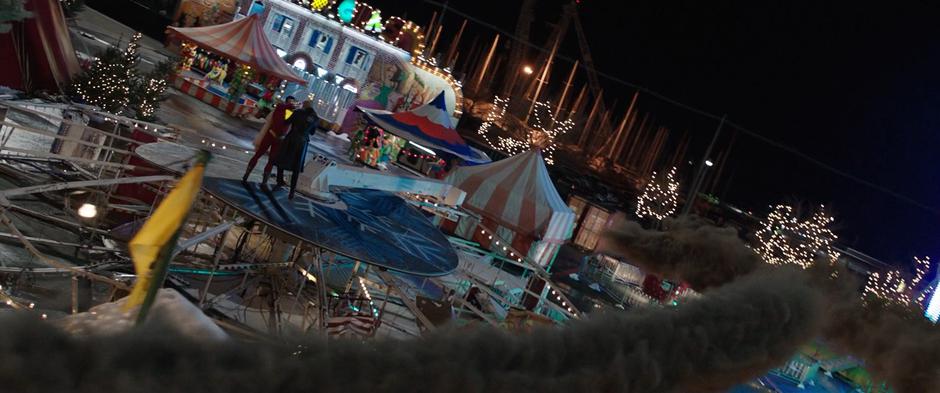Billy holds Sivana on top of the fallen ferris wheel while his creatures fly back to him as smoke.