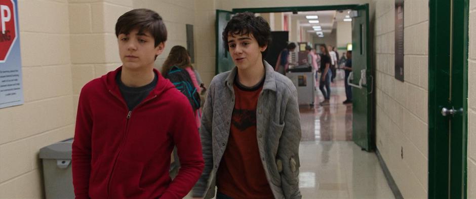 Freddy talks to Billy as they walk down the hallway after eating their lunch.