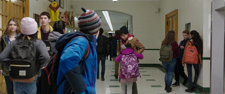Freddy watches as Darla gives Billy a hug in the hallway.
