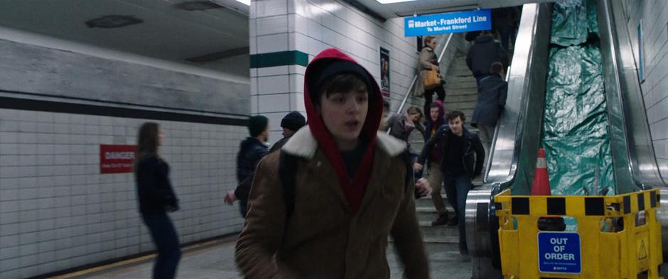 Billy runs across the subway platform while Brett and Burke Breyer chase after him.
