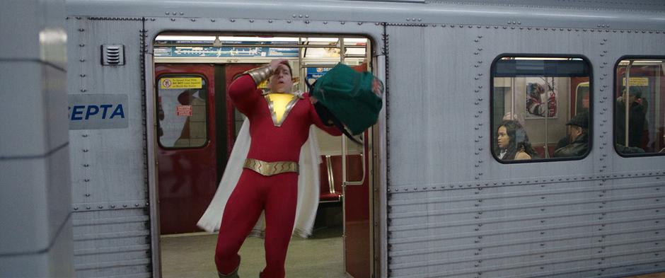 Billy holds his forehead as he exits the subway car in his new superhero form.
