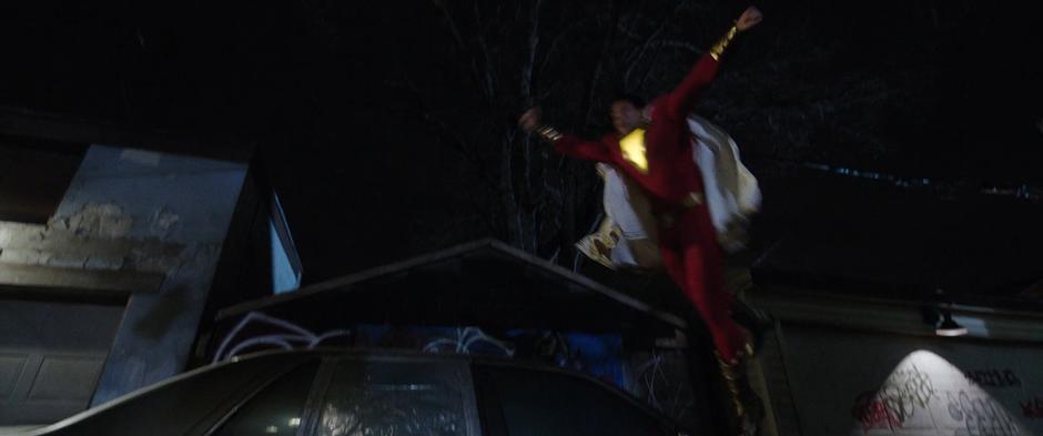 Billy leaps off a car and through the air in an attempt to fly.