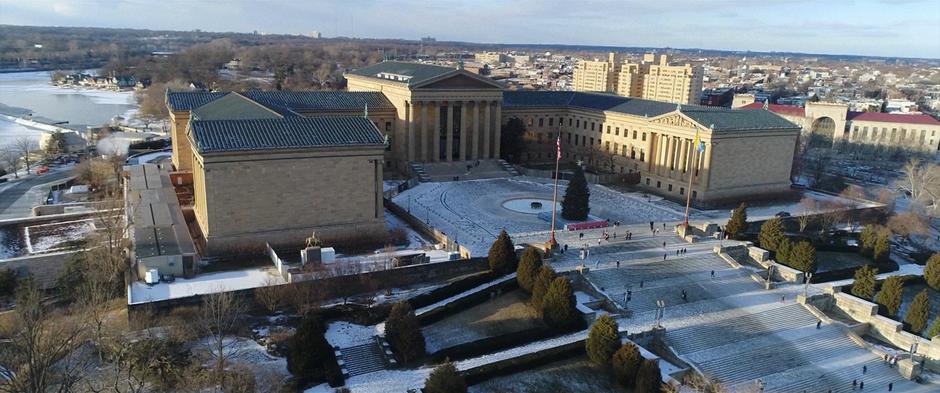 Aerial establishing shot of the Philadelphia Museum of Art during the day.