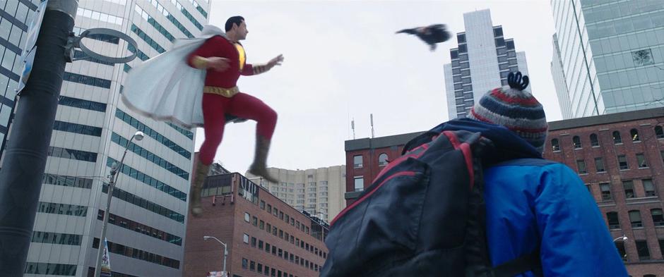 Freddy watches as Sivana flies towards Billy above the intersection.