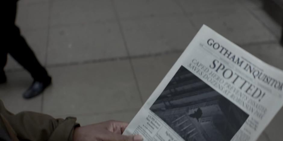 A man looks down at the newspaper article on Kate's heroics.