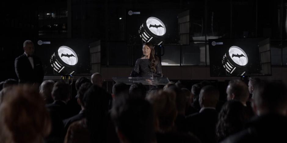 Catherine addresses the crowd before the shutdown of the Bat-Signal.