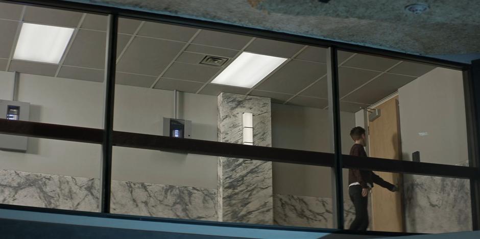 Kate leaves the observation room after her father's briefing.