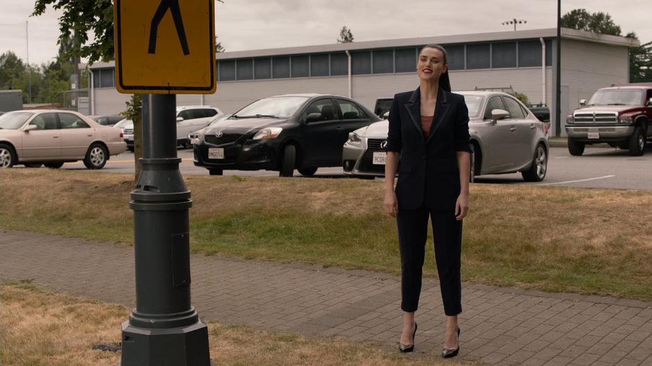 Lena smiles as Kara as she walk over to where she is standing on the sidewalk.