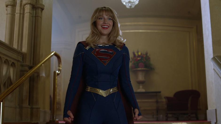 Kara smiles at Lena after donning her new suit for the first time and realizing it has pants.