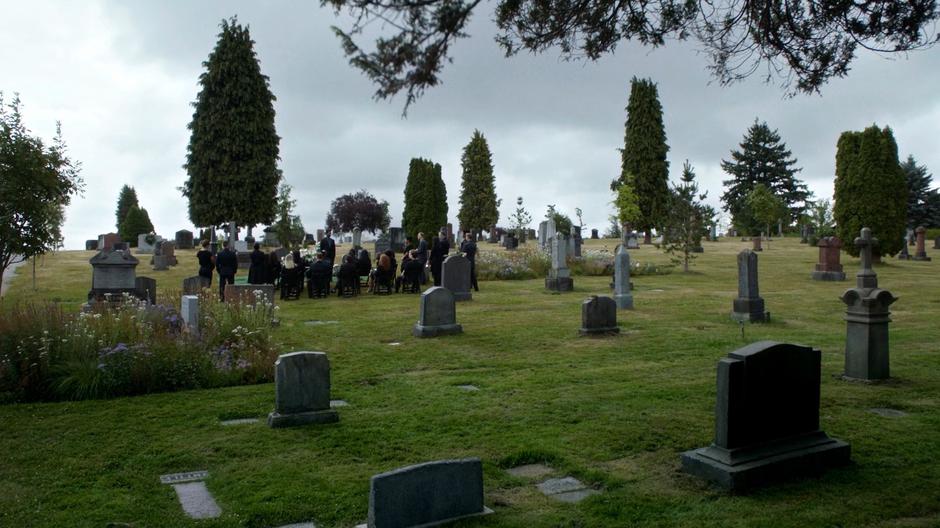 A group of mourners surround Rachel Rosso as Ramsey gives a eulogy.