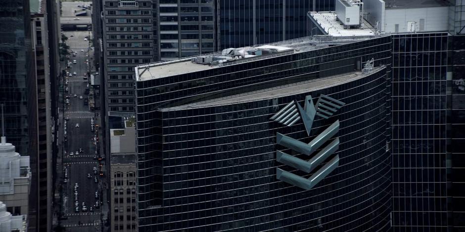 View of the large logo on the office building during the daytime.