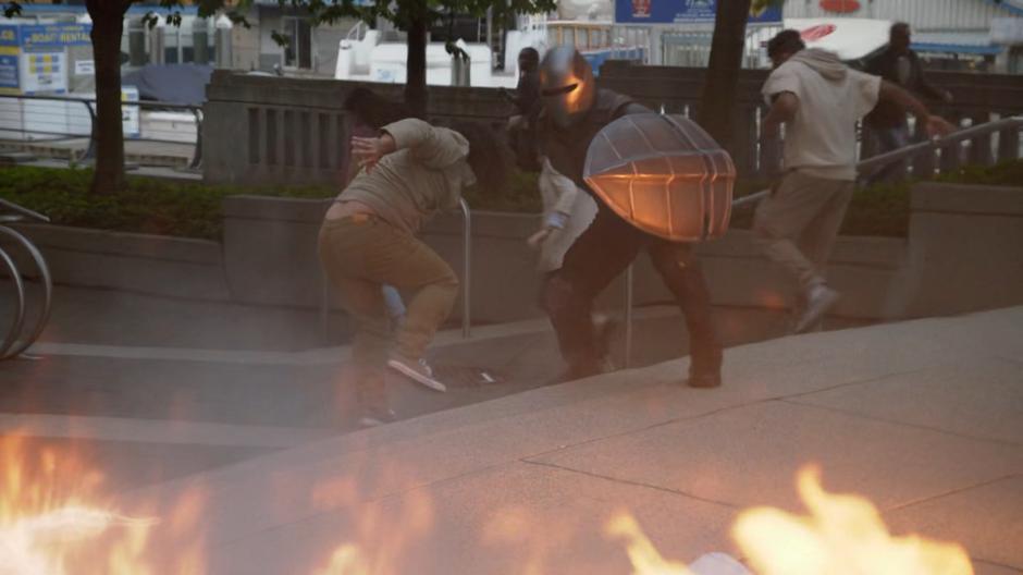 James guides some bystanders to safety away from a fire.