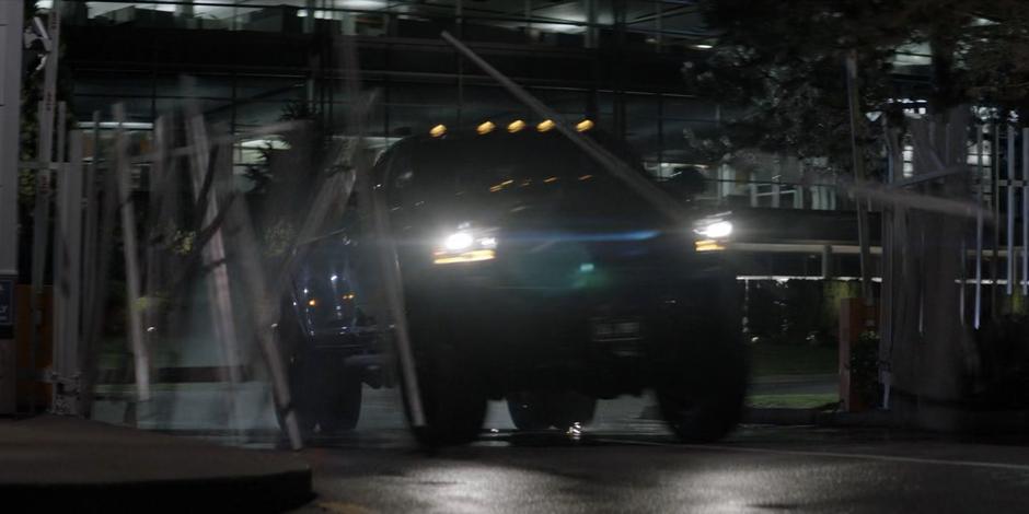 A truck crashes through the gate leading to the facility.