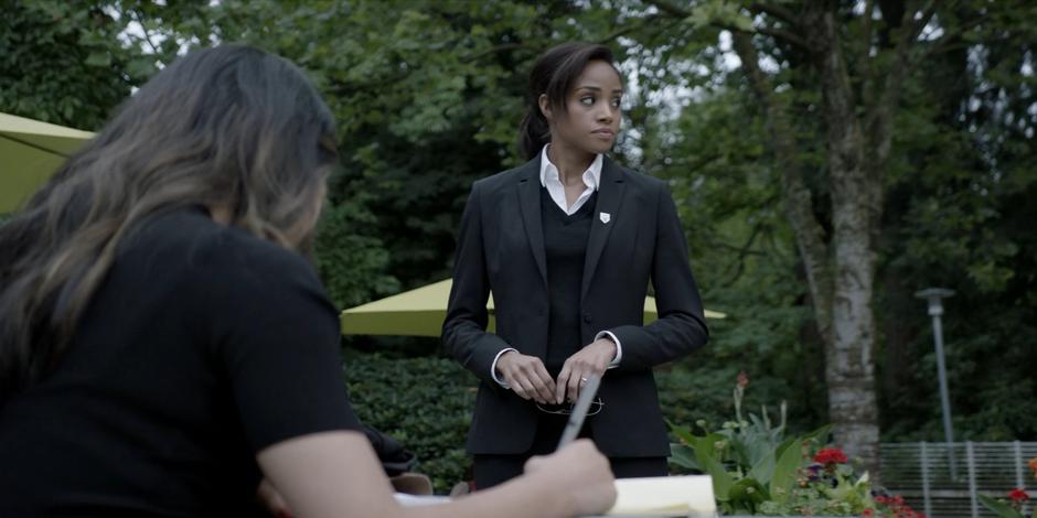 Sophie takes off her sunglasses and glances around before sitting down with Mary.