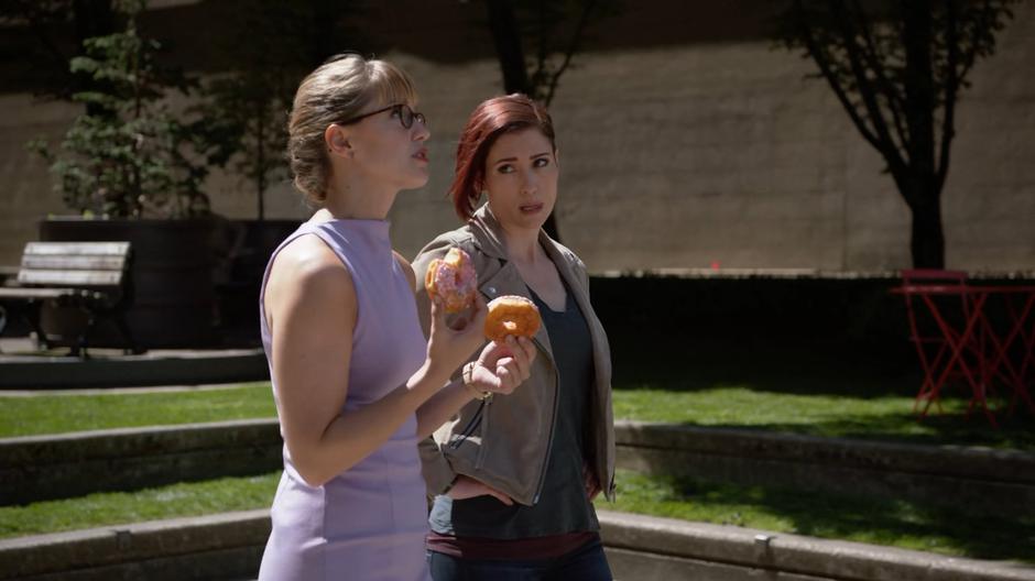 Alex looks over at Kara as she explains her nervousness over her lunch with Lena as she eats two donuts.