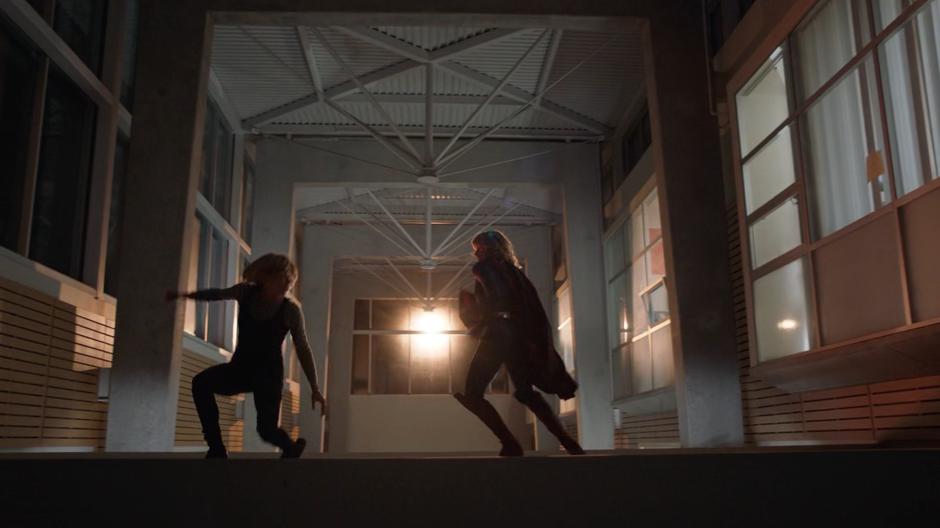 Caroline O'Conner and Kara fight on a platform near the ceiling.