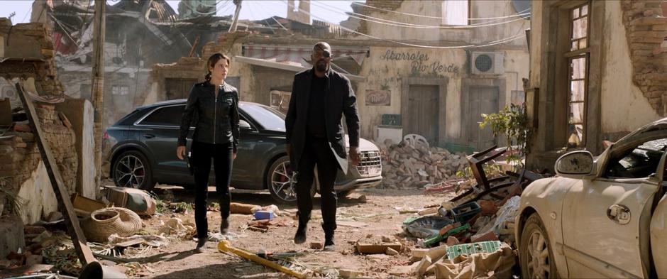 Hill and Fury walk away from their car looking for clues as to what happened to the town.