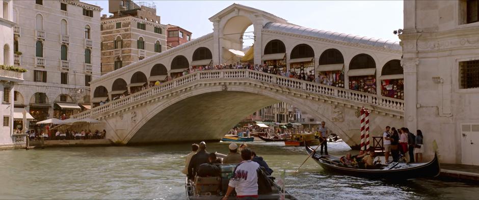 The tour boat drives beneath the busy bridge.