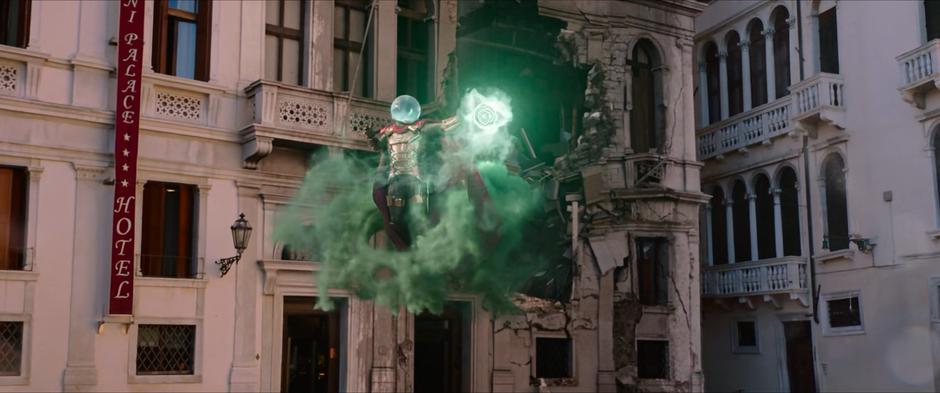 Mysterio charges up a green blast to shoot at the water elemental.
