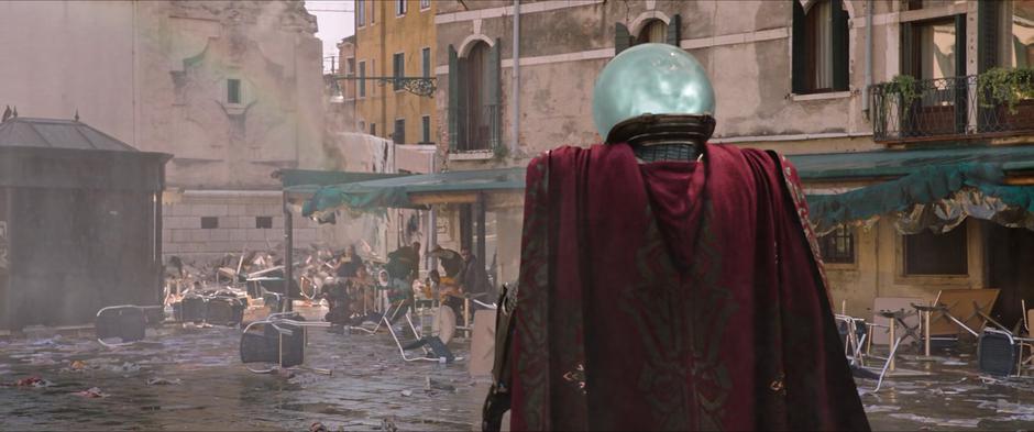 Mysterio lands in the square and looks over at the students after defeating the elemental.