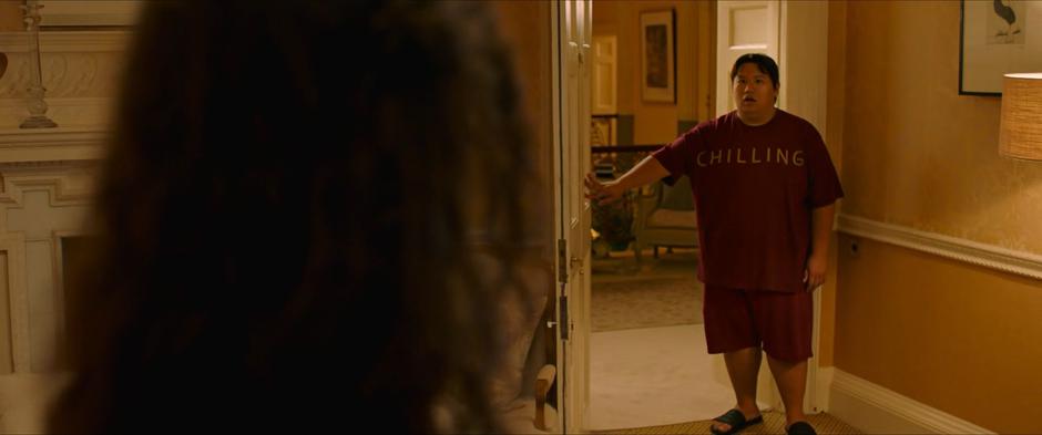 Ned opens the door to Peter's room and is surprised to find Peter changing into his costume with MJ in the room.