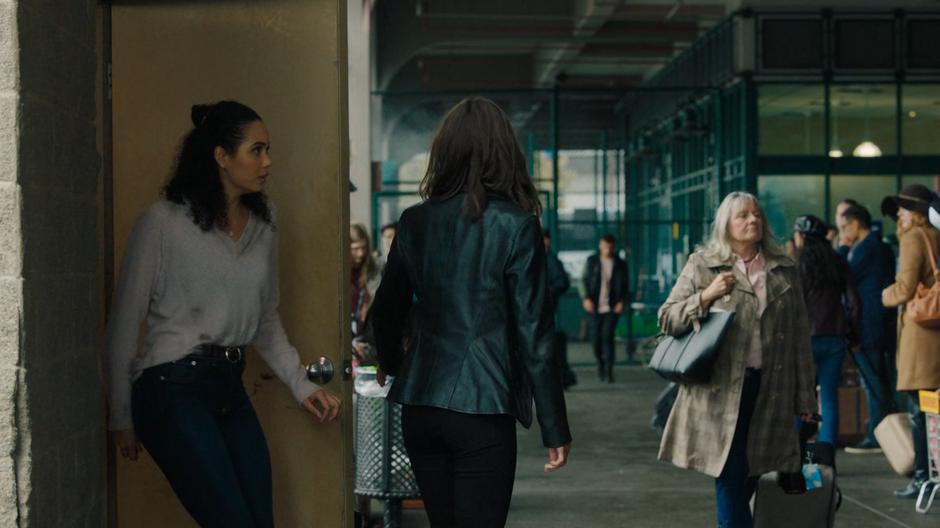 Macy follows Abigael out of the storage room onto the train station platform.