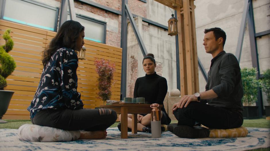 Mel and Harry listen to Katrina as she guides them through the meditation.