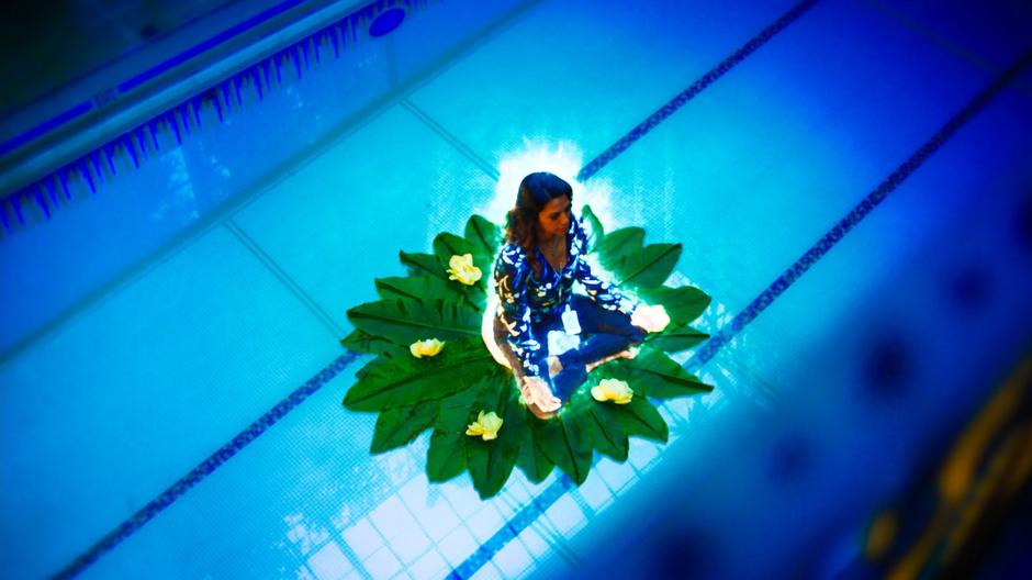 A vision of Katrina sits on a lilly pad in the middle of the pool down below.