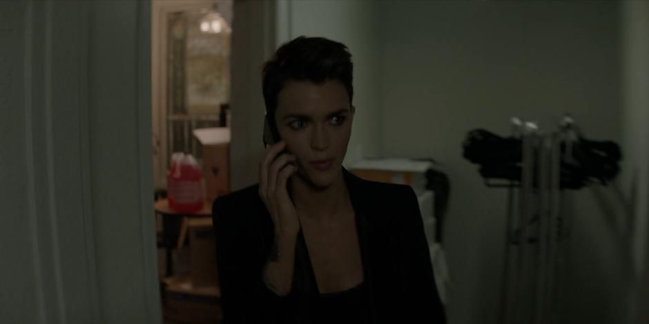 Kate calls Luke on the phone while she heads to where she stashed her gear.