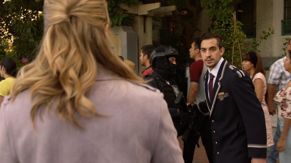 Kara approaches the doorman outside the building and asks what is happening.