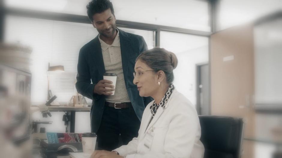 Ramsey brings his mother coffee while she is working on her computer.