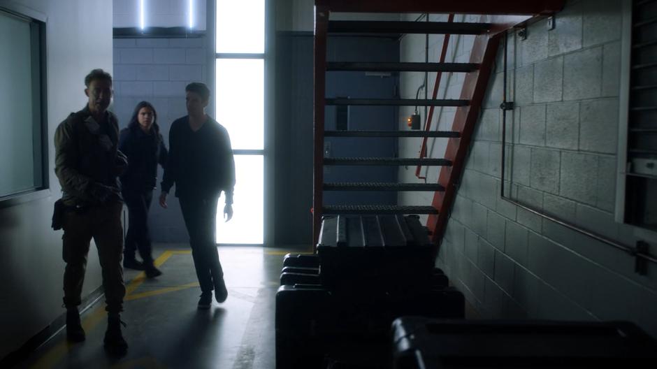 Nash leads Cisco and Barry around the corner through the lab.