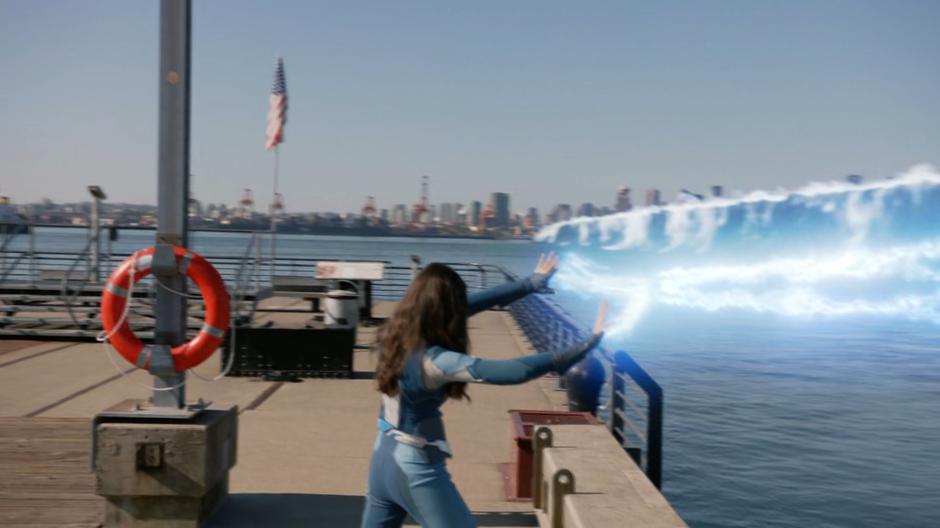 Nia tries to stop the tidal wave with her powers as it races towards the city.