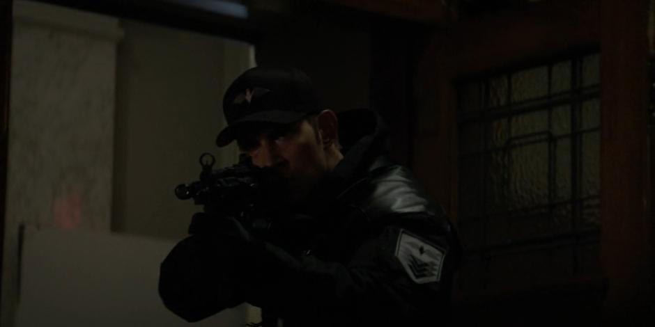 Tyler stands in the door of the courtroom with his gun ready as he sees Jacob and Batwoman.