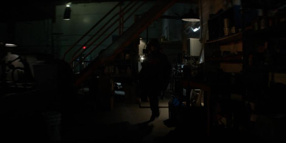 Kate runs through the warehouse towards the screams.