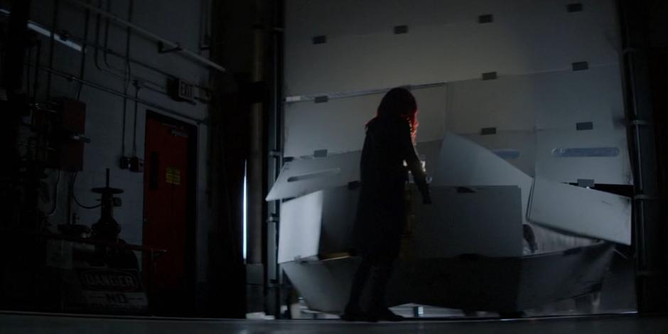 Kate stands in front of the warehouse door as the Executioner bursts through in his truck.