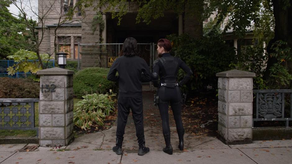 Brainy and Alex stand on the sidewalk in front of the headquarters that looks abandoned.