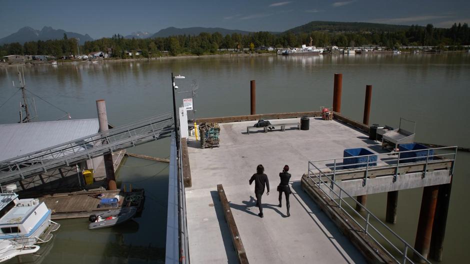 Brainy and Alex walk down onto the dock where Russell is apparently lying on a bench.