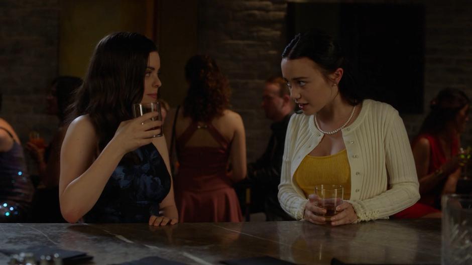 Young Lena leans towards Andrea and nervously asks why they weren't carded.