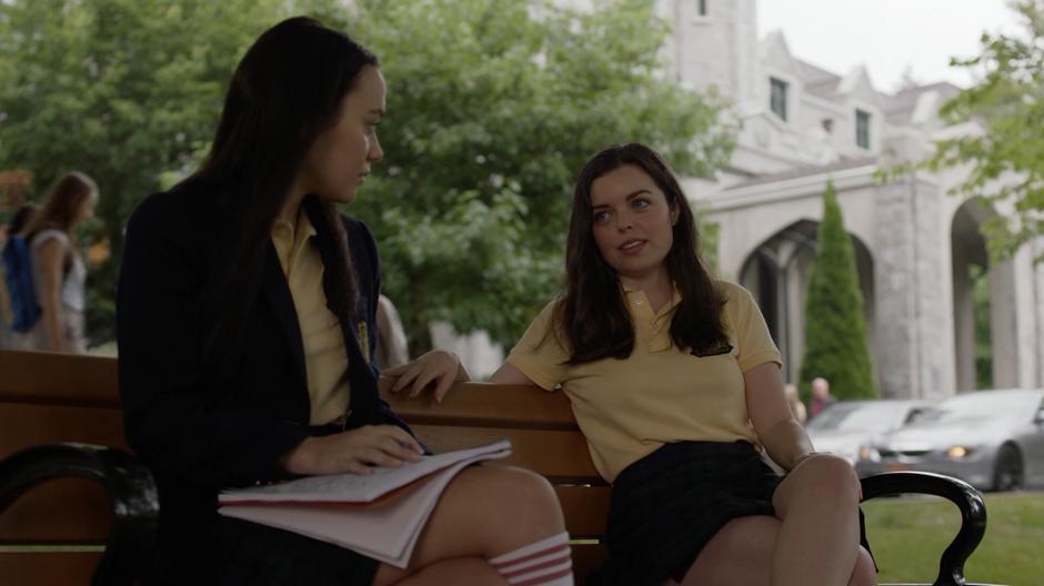 Young Lena looks at Andrea as Andrea talks about why her parents aren't there.