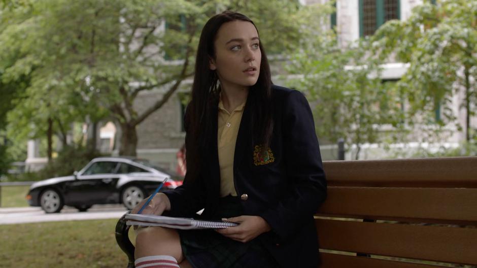 Young Lena looks up as Andrea sits next to her.