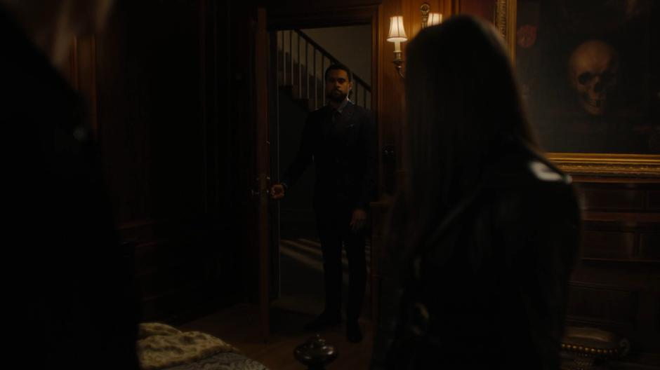 Godric opens the door to interrupt Parker and Maggie's conversation.