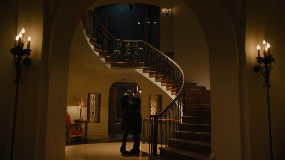 Maggie and Parker kiss in the main stairwell.