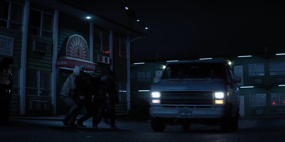 Several members of the Wonderland gang grapple Jacob as their van arrives.
