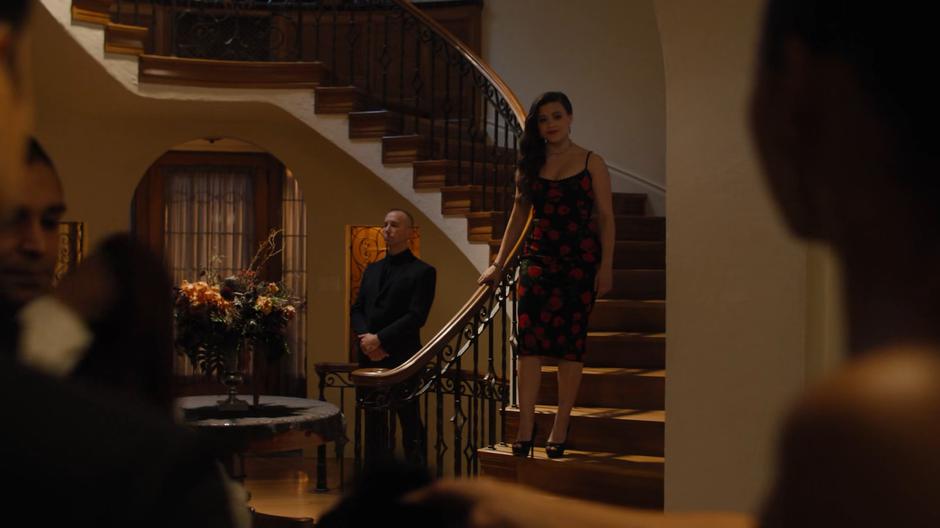Maggie walks down the stairs to greet Harry and her sisters.