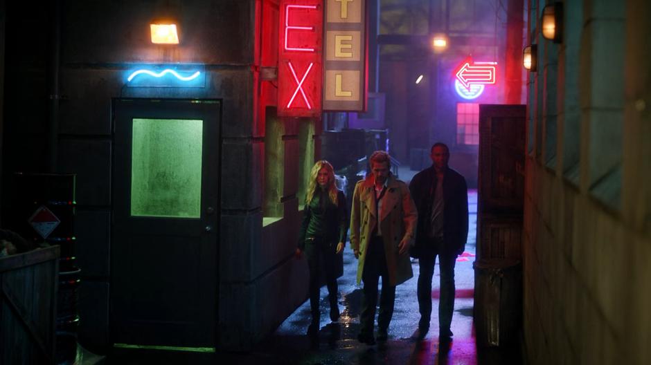 Constantine leads Mia and Diggle down a seedy alley in Los Angeles.